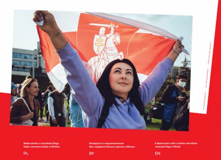 Photograph from the exhibition Belarus. road to freedom. A woman holding the national Belarusian flag with an emblem during a demonstration in Minsk.